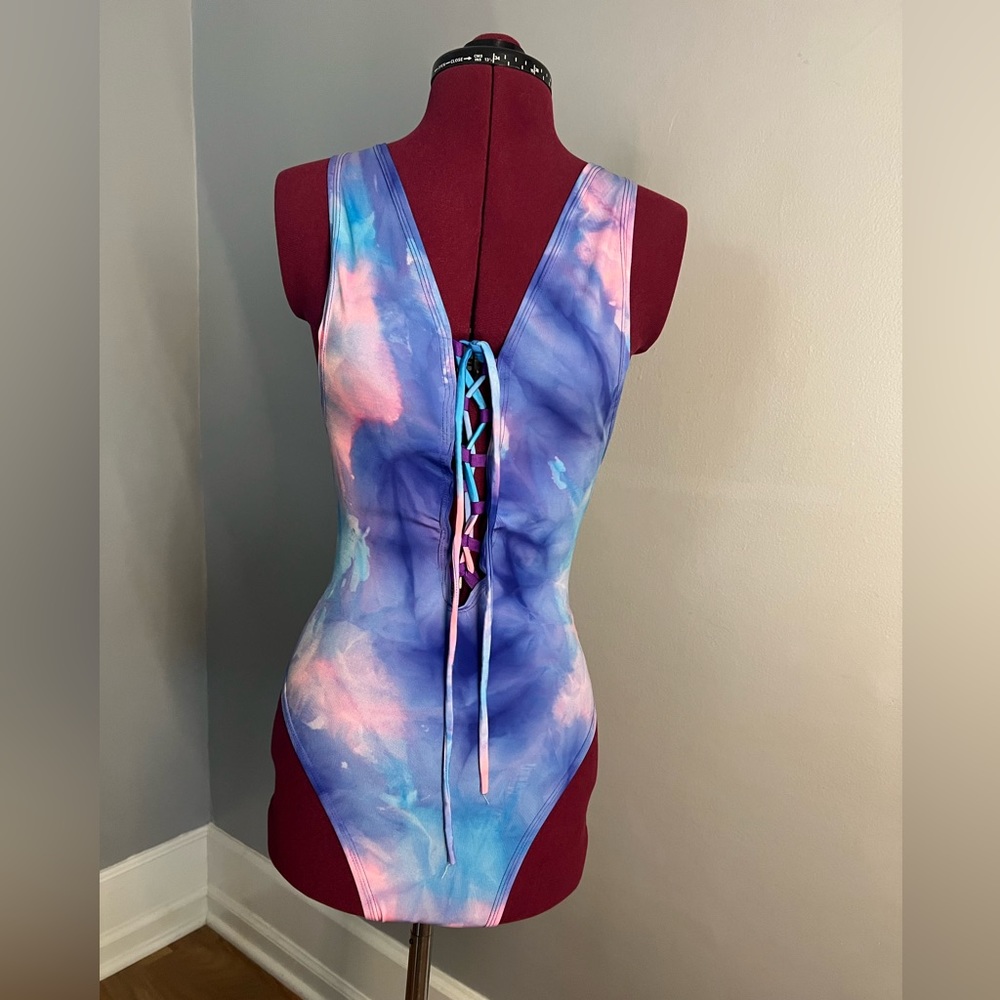 Eat. Rave. Sleep one piece with multi blue/ pink / purple colors mixed.